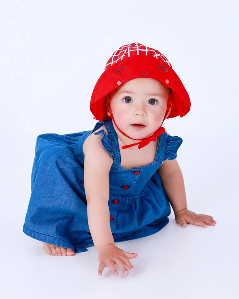 Bonnet en tricot rouge pour fille avec carreaux blancs et visage brodé