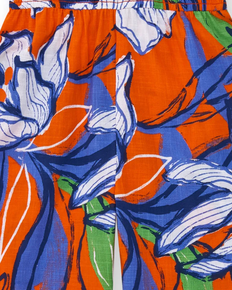 Combinaison longue pour fille en orange avec épaules dénudées.