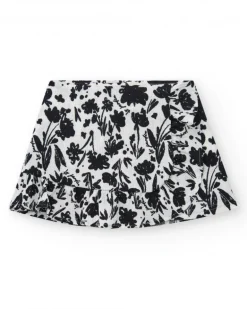 Jupe pour fille en blanc avec imprimé floral et volant.