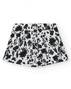 Jupe pour fille en blanc avec imprimé floral et volant.