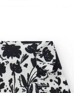 Jupe pour fille en blanc avec imprimé floral et volant.
