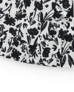 Jupe pour fille en blanc avec imprimé floral et volant.