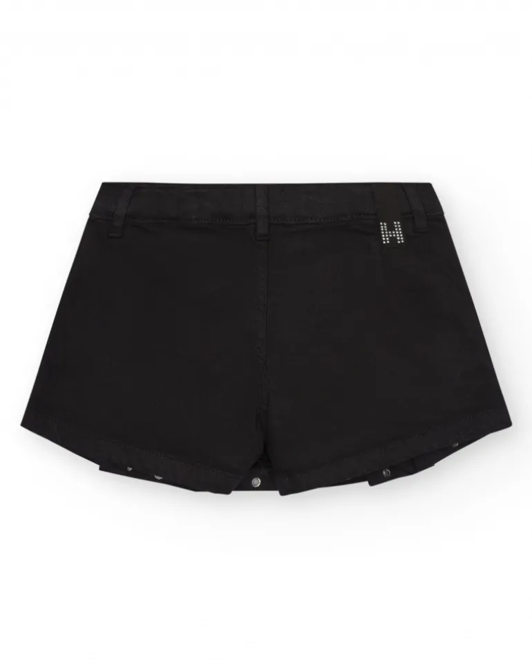 Jupe-short pour fille en noir avec détails métalliques.