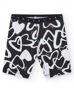 Legging cycliste pour fille en noir avec cœurs imprimés et taille décorée de clous.