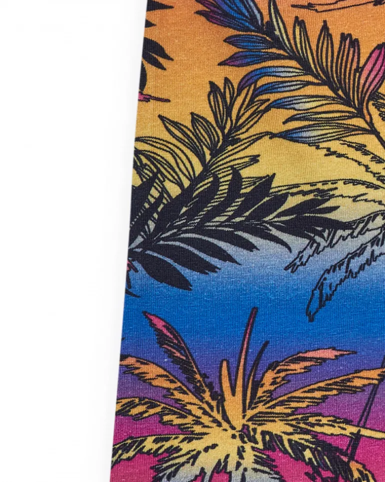 Legging cycliste pour fille avec imprimé tropical et taille élastique.