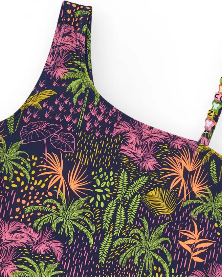 Maillot de bain pour fille en bleu marine avec design asymétrique et imprimé tropical.
