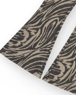 Pantalon pour fille en noir avec imprimé animal et clous à la taille.