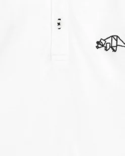 Polo blanc pour garçon avec bordures noires et broderie de dinosaure