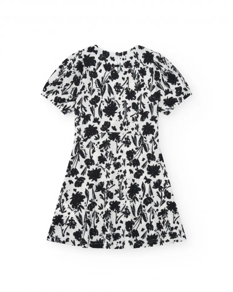 Robe pour fille en blanc et noir avec manches bouffantes et imprimé floral.