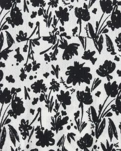 Robe pour fille en blanc et noir avec manches bouffantes et imprimé floral.