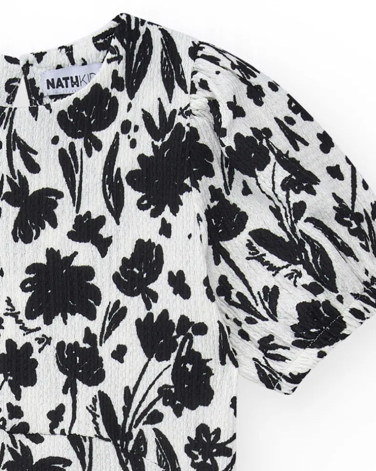 Robe pour fille en blanc et noir avec manches bouffantes et imprimé floral.