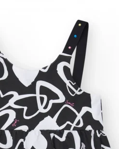 Robe pour fille en noir avec bretelles ajustables et appliques.