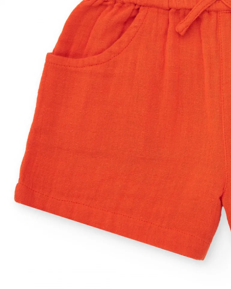 Short orange pour fille avec nœud et poches latérales