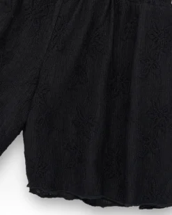 Short pour fille en noir avec taille élastique et imprimé floral.