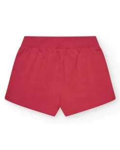 Short pour fille en rouge avec taille élastique et poches.
