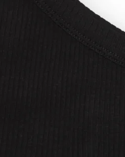 Top asymétrique pour fille en noir avec motif floral.