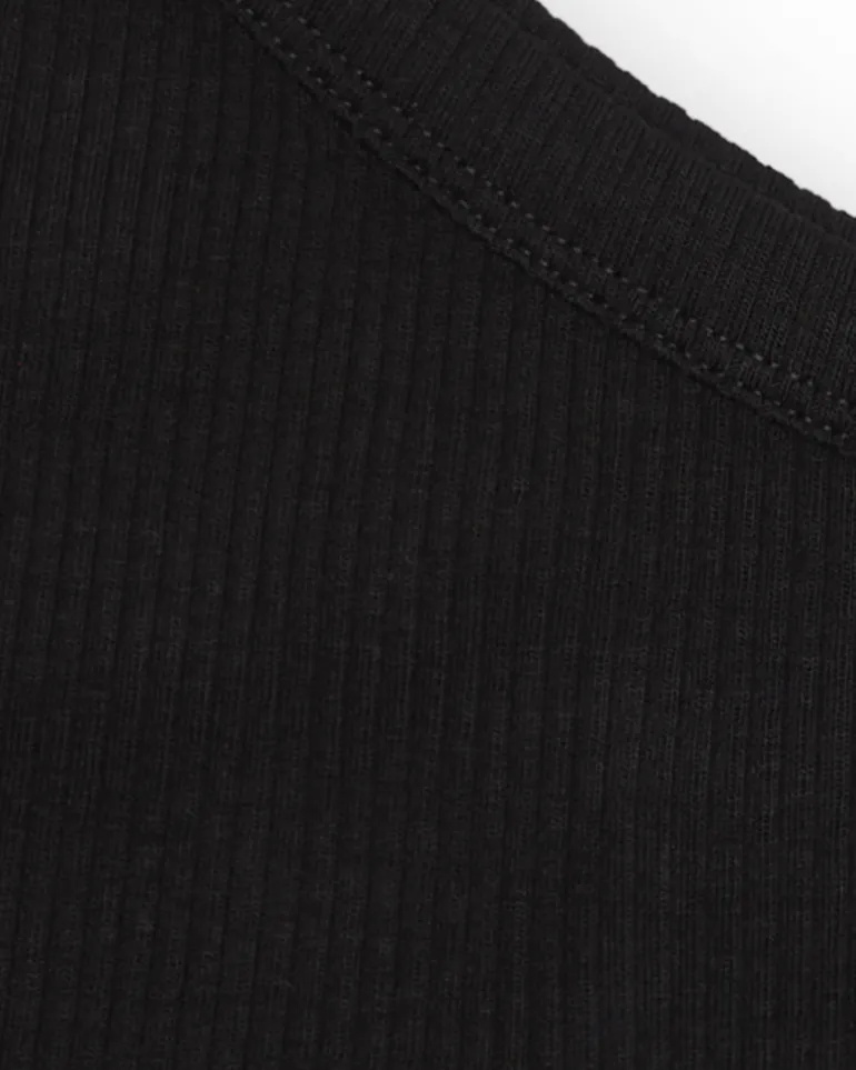 Top asymétrique pour fille en noir avec motif floral.