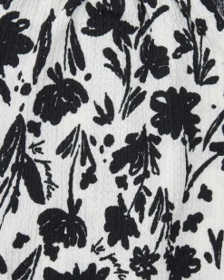 Top pour fille en blanc avec bretelles et imprimé floral.