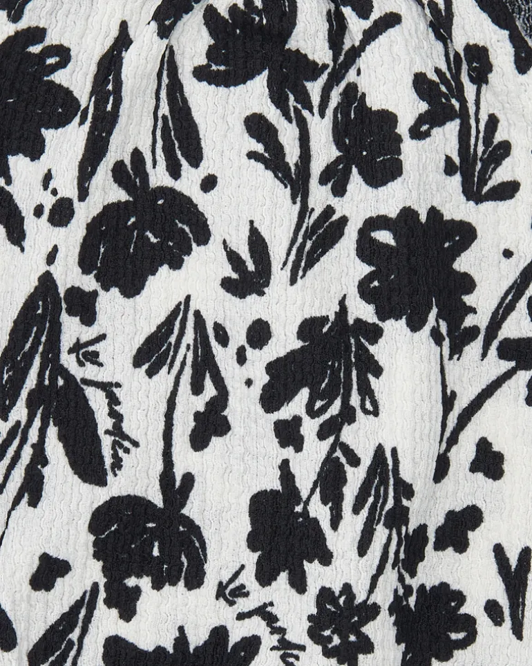 Top pour fille en blanc avec bretelles et imprimé floral.