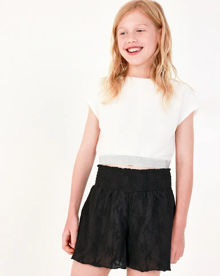 T-shirt pour fille en blanc avec sequins et ourlet élastique.