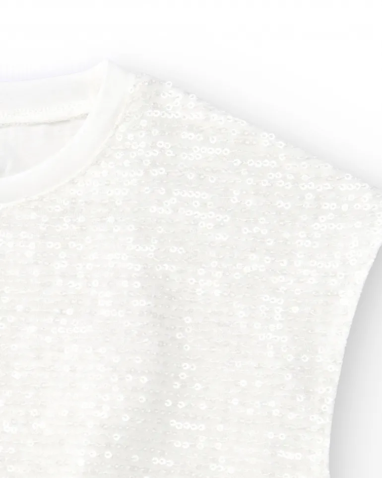 T-shirt pour fille en blanc avec sequins et ourlet élastique.